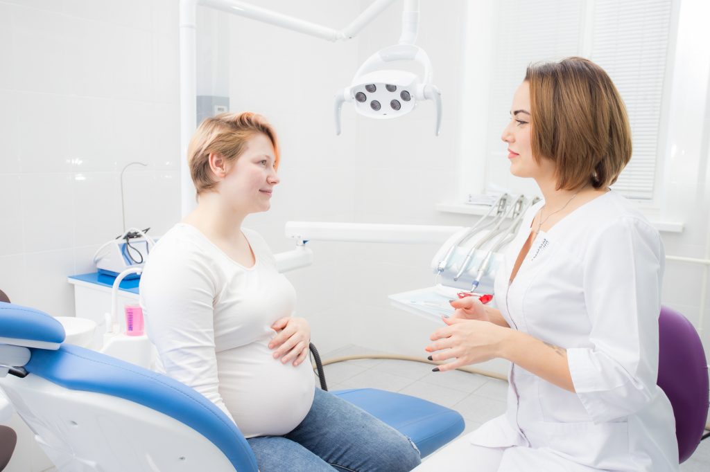 What should a pregnant woman do to ensure good oral health?